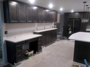 In-progress kitchen remodel with new cabinets, granite countertops prior to backsplash installation